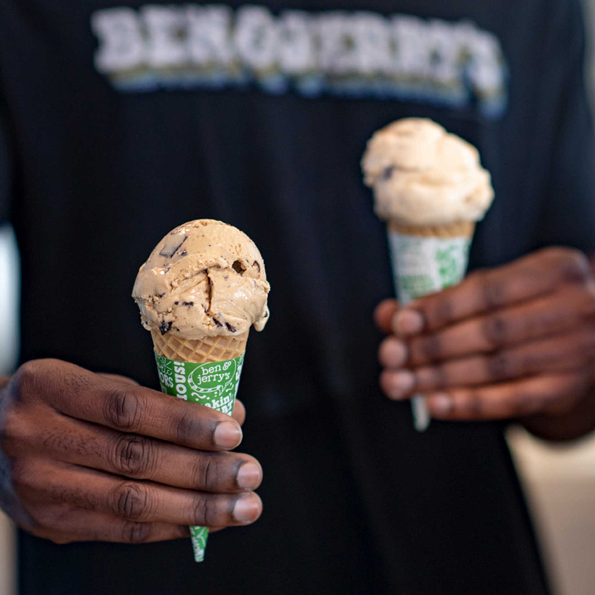 Hands holding two ice cream cones