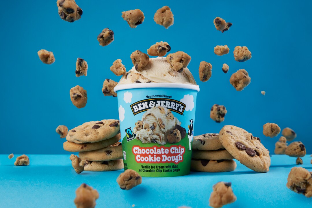 A pint of Chocolate Chip Cookie Dough ice cream surrounded by cookies