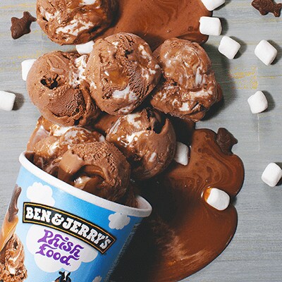 A pint of Phish Food pouring out onto the table