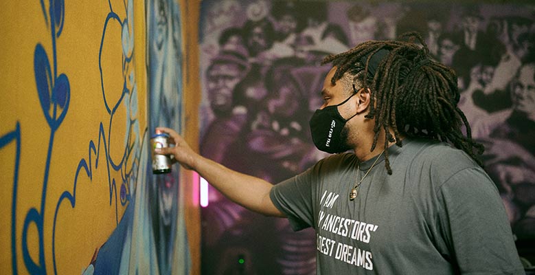 BMike spay painting a wall